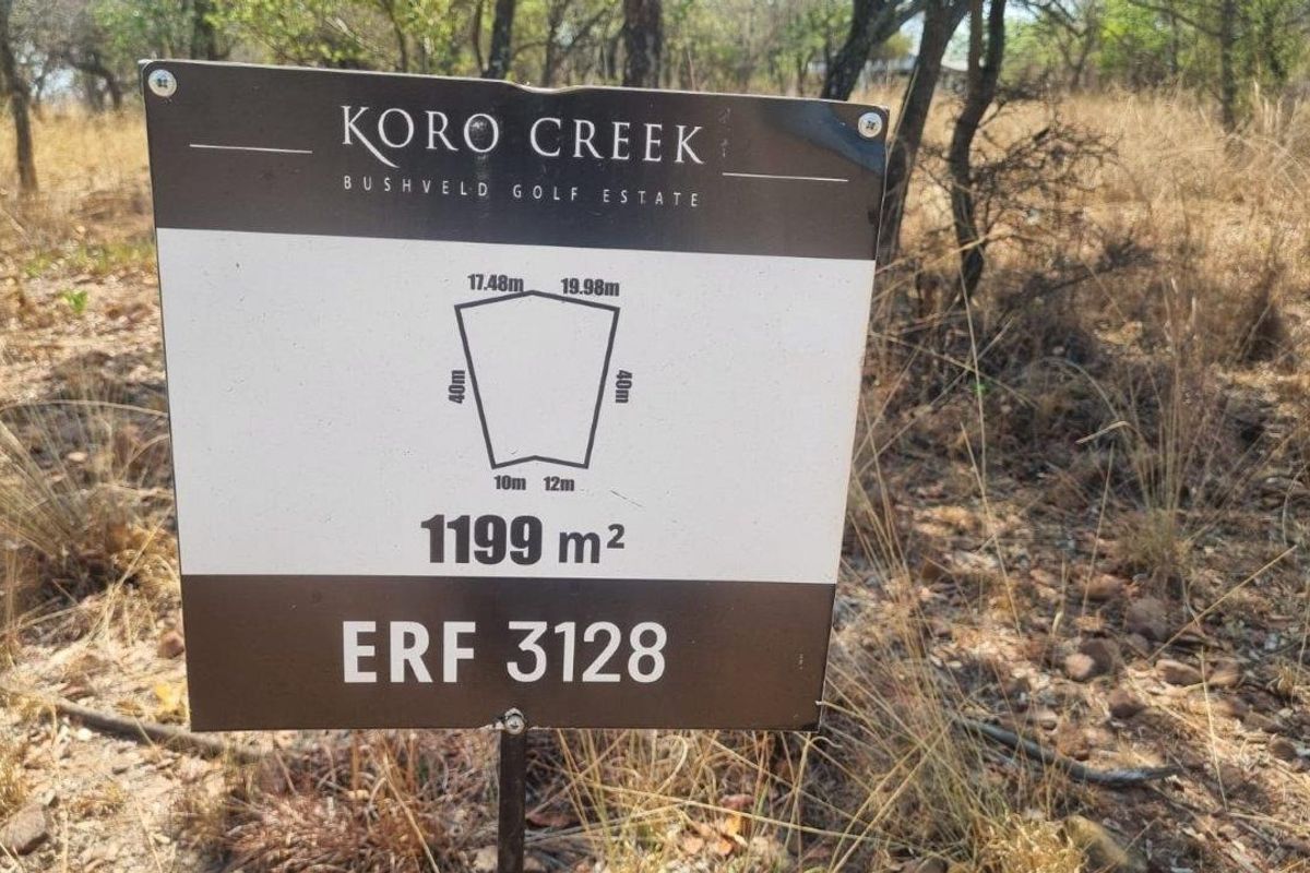A property signage board displaying the erf number and dimensions for a 1199 square meter vacant residential stand in Koro Creek Bushveld Golf Estate.