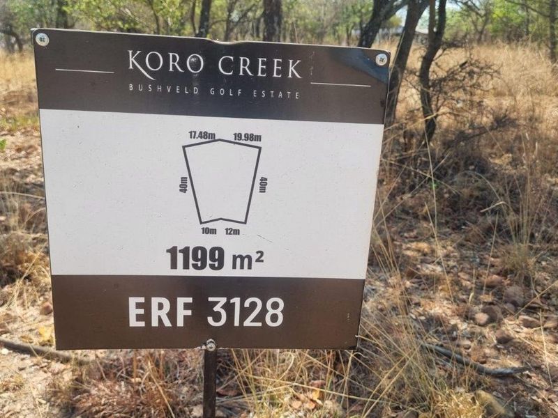 A property signage board displaying the erf number and dimensions for a 1199 square meter vacant residential stand in Koro Creek Bushveld Golf Estate.