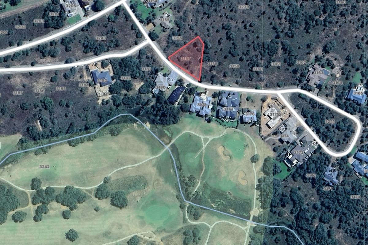 Aerial view of a vacant residential land plot situated within a developed estate, highlighting its location and surrounding landscape.