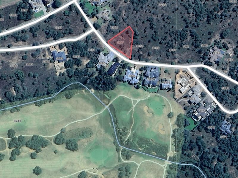 Aerial view of a vacant residential land plot situated within a developed estate, highlighting its location and surrounding landscape.