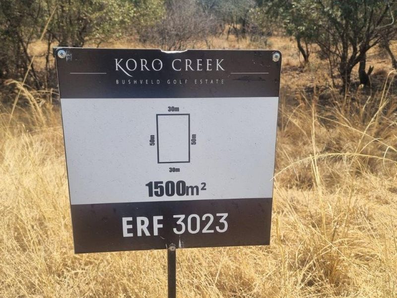 A clear signage board displaying the dimensions and erf number for a 1500 square meter vacant residential plot in Koro Creek Bushveld Golf Estate.