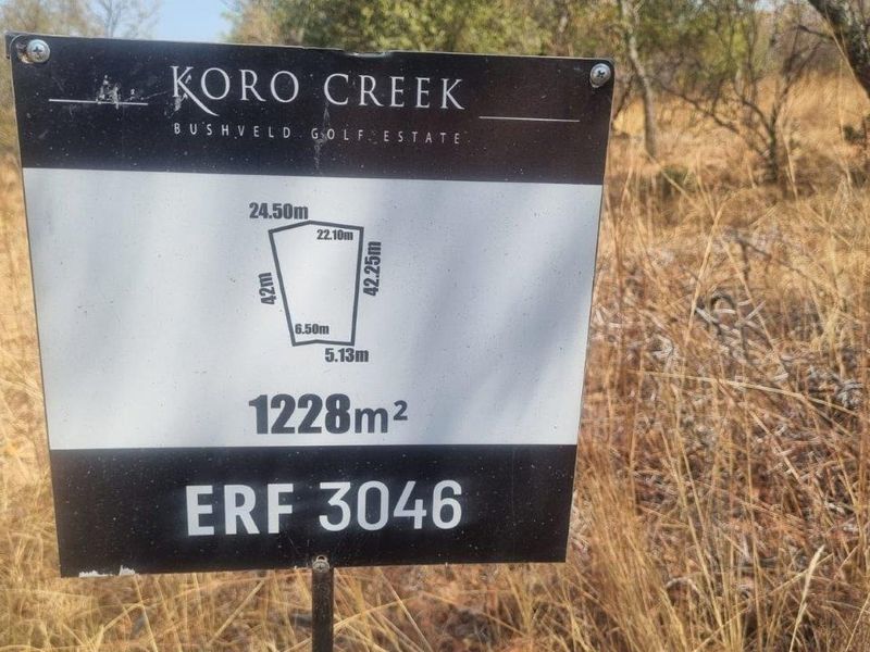 A property signage board for Erf 3046 in Koro Creek Bushveld Golf Estate, displaying the plot dimensions and total area of 1228 square meters.