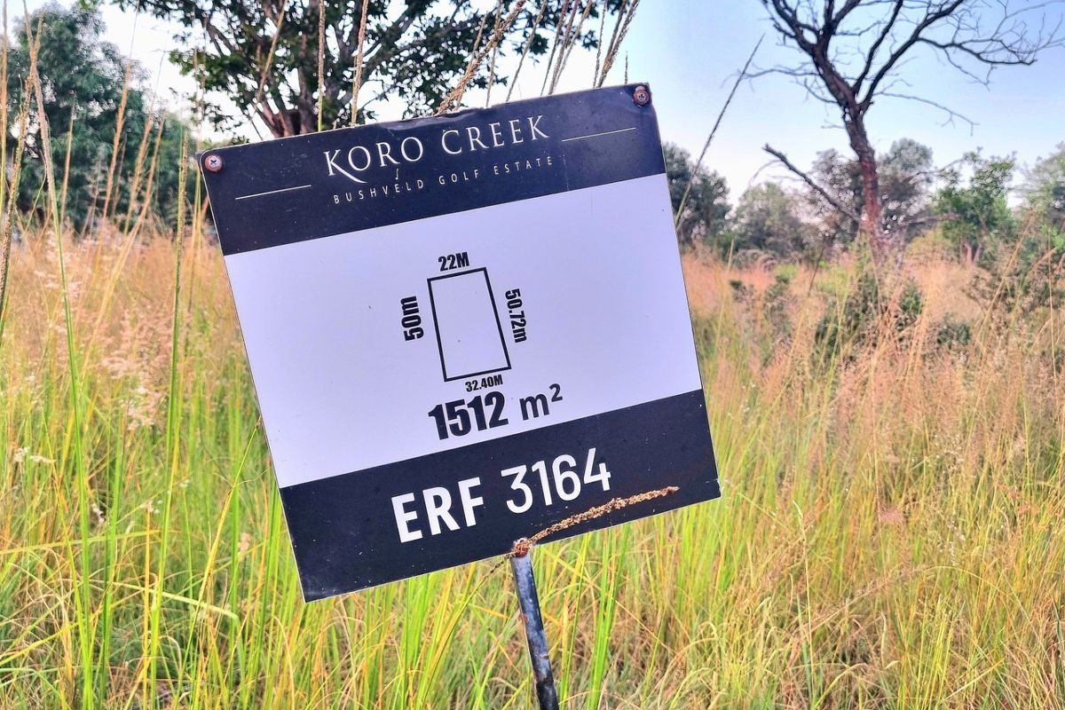 A signage board displaying the dimensions and erf number for a 1512 square meter vacant residential plot in Koro Creek Bushveld Golf Estate.