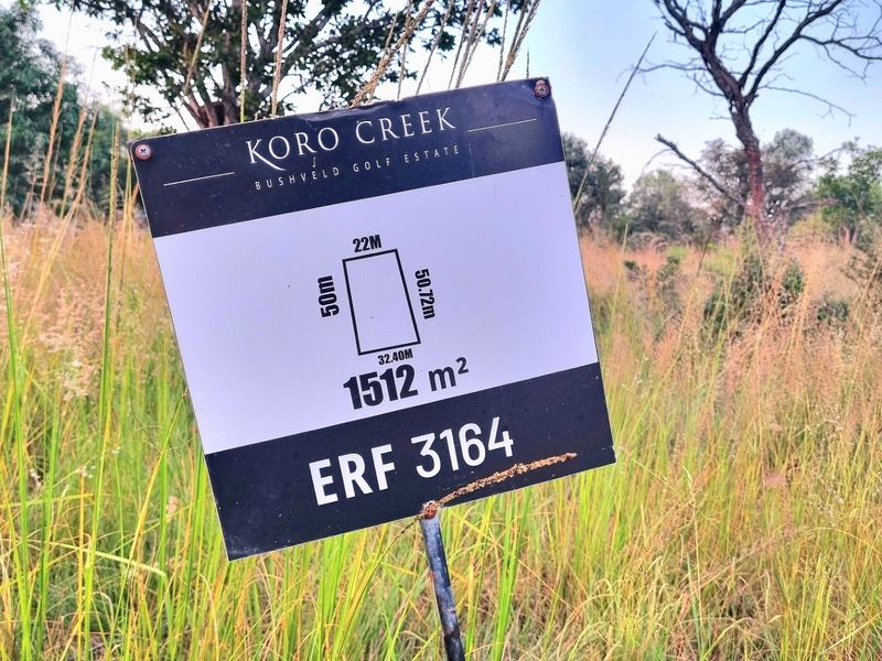 A signage board displaying the dimensions and erf number for a 1512 square meter vacant residential plot in Koro Creek Bushveld Golf Estate.