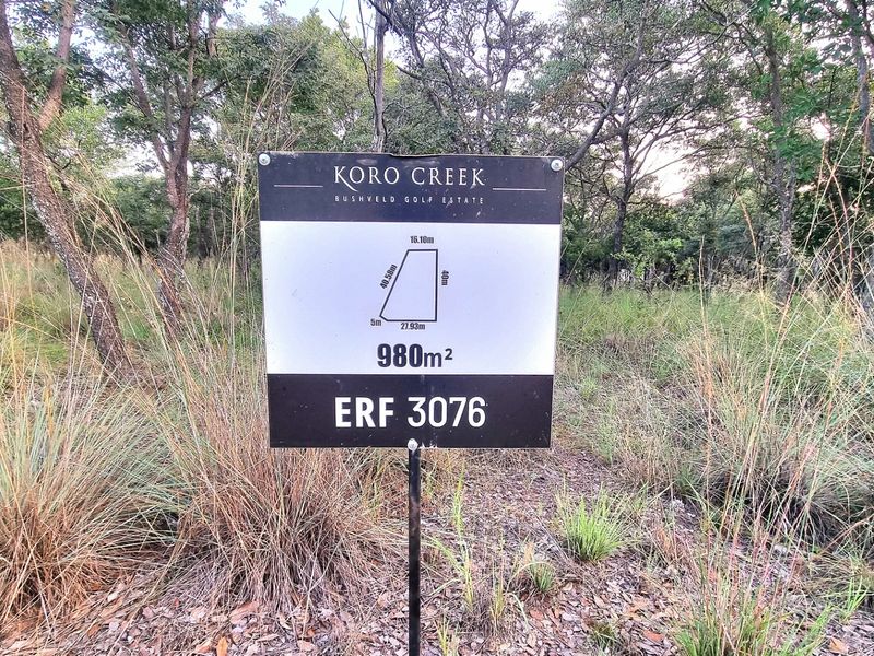A vacant residential stand measuring 980 square meters located within the Koro Creek Bushveld Golf Estate, featuring natural vegetation and clear boundary signage.
