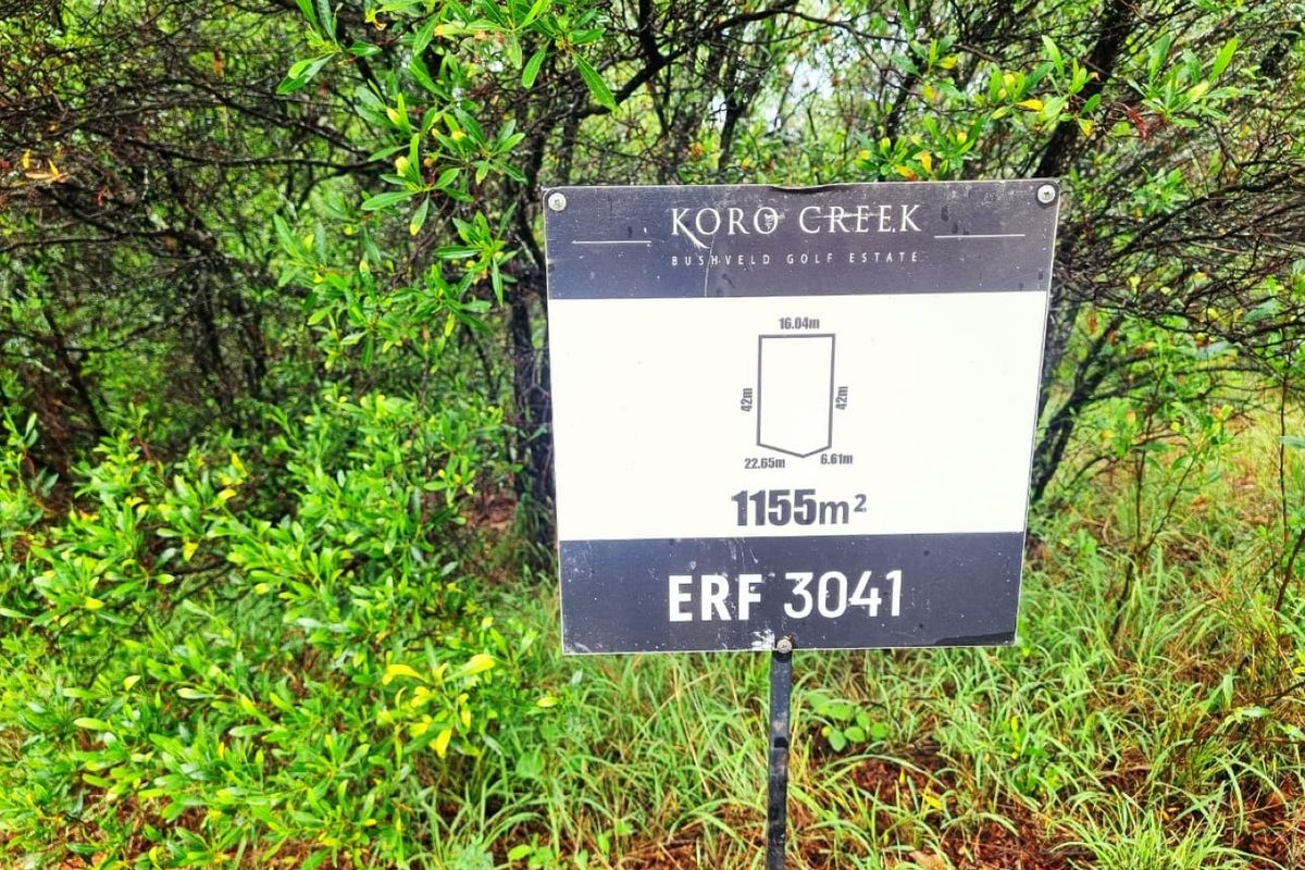 A sign displaying the erf number and dimensions for a 1155 square meter vacant residential plot located in Koro Creek Bushveld Golf Estate.