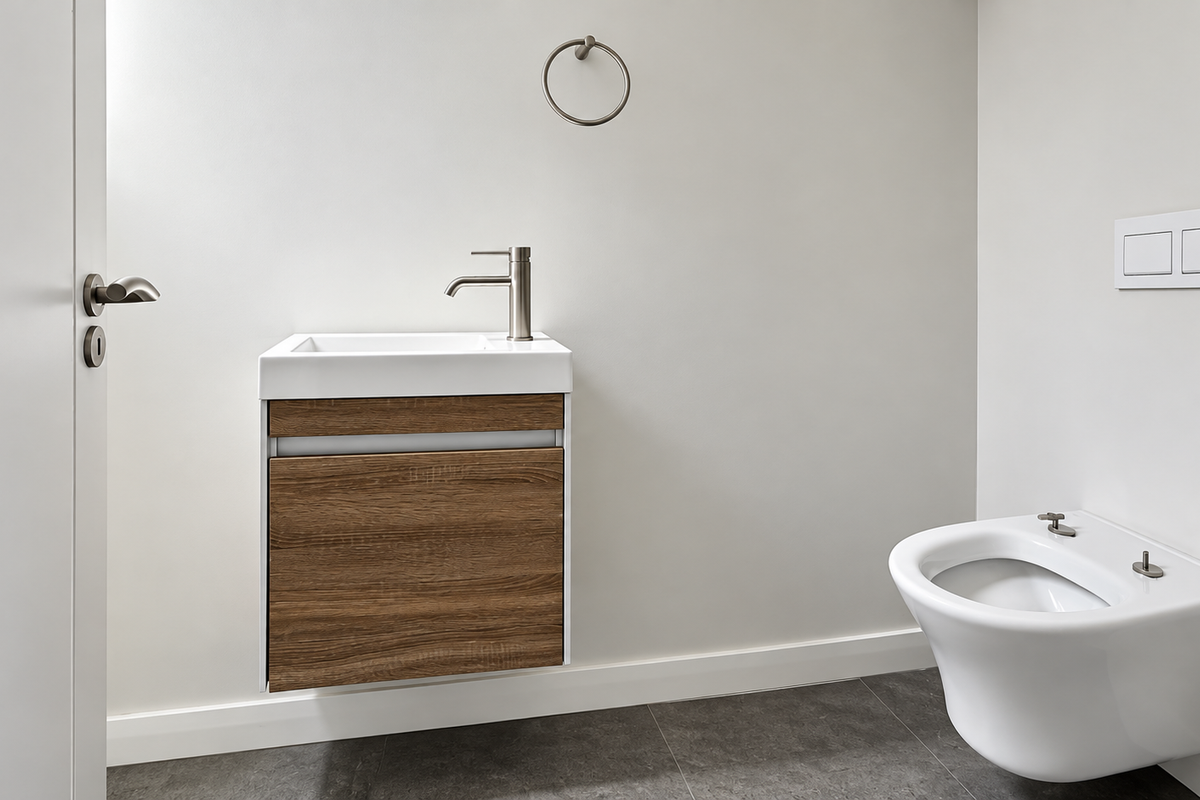 A modern, minimalist guest bathroom featuring a wall-mounted wood-finish vanity with basin and a wall-hung toilet with a concealed cistern.