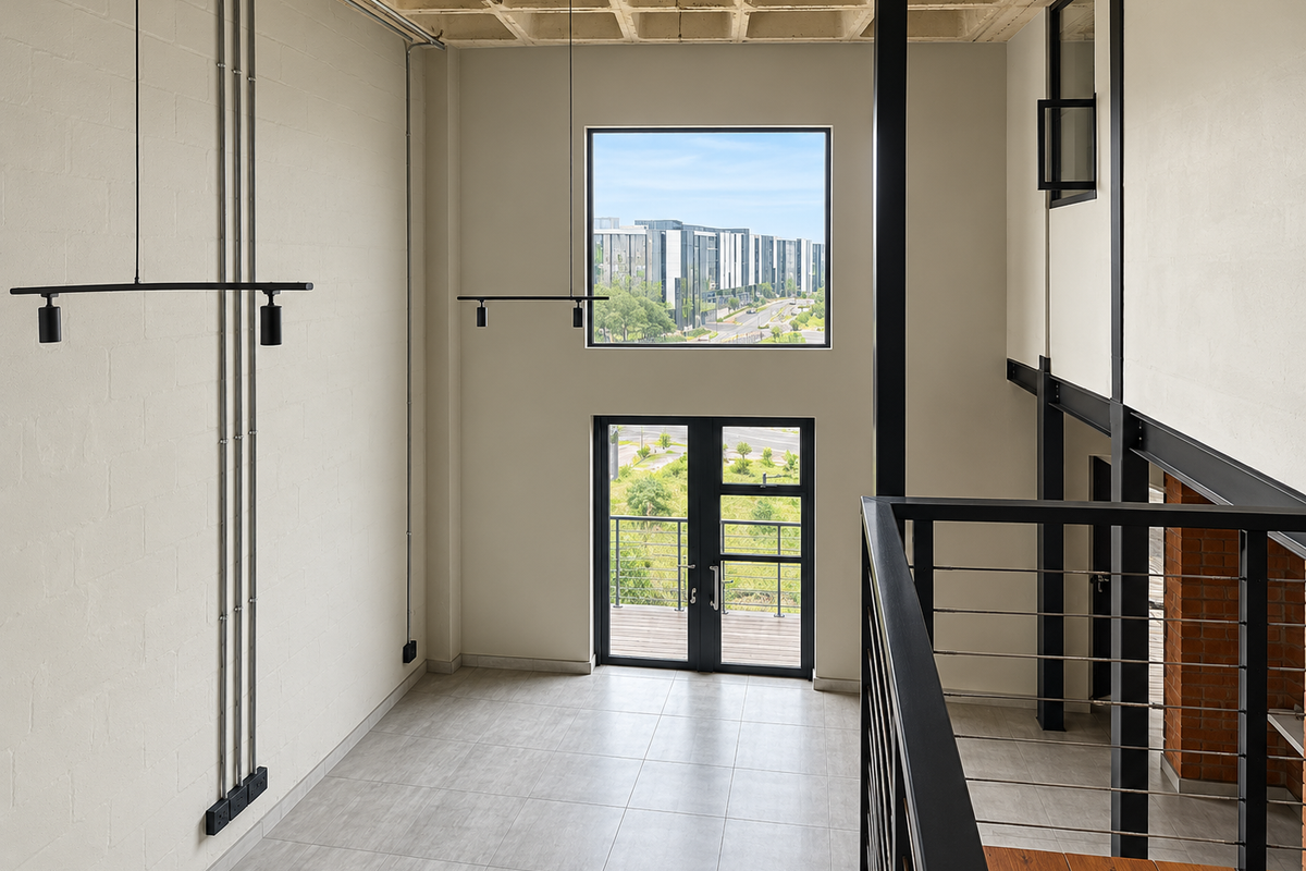 Spacious double-volume living area featuring industrial-style exposed concrete ceilings, steel structural elements, tiled flooring, and large windows with views.