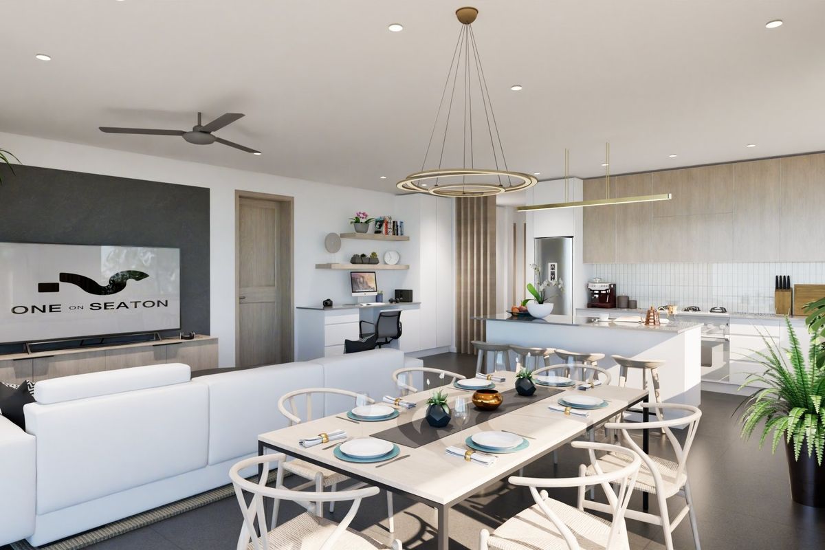 Modern open-plan living, dining, and kitchen area featuring contemporary cabinetry, a central island, built-in desk space, and high-quality finishes throughout.
