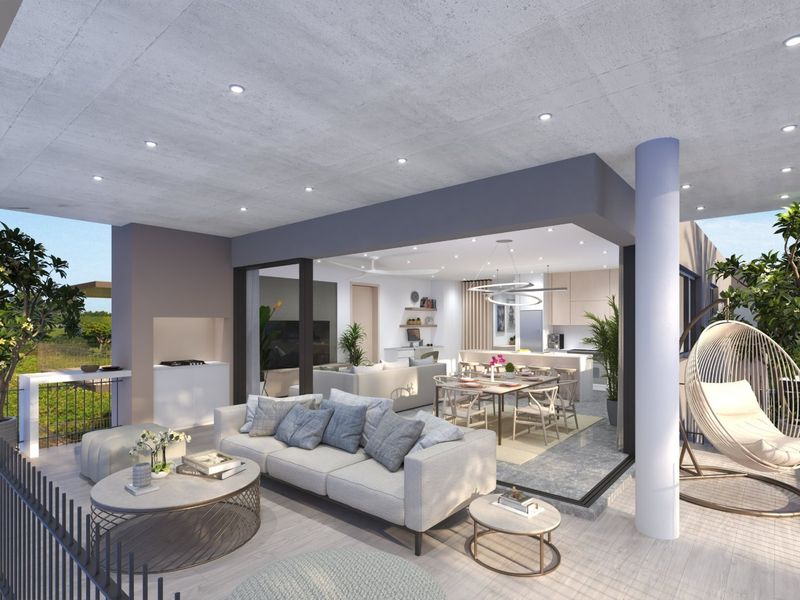 Spacious covered balcony featuring a built-in braai, recessed lighting, and seamless flow into the open-plan interior living and kitchen area.