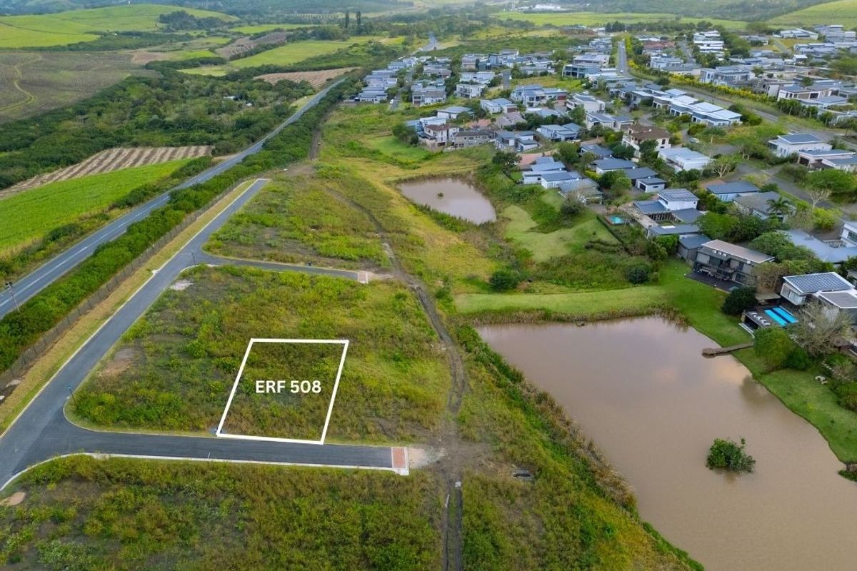 Aerial view of vacant residential plot ERF 508, situated in a developed estate with access to paved roads and nearby water features.