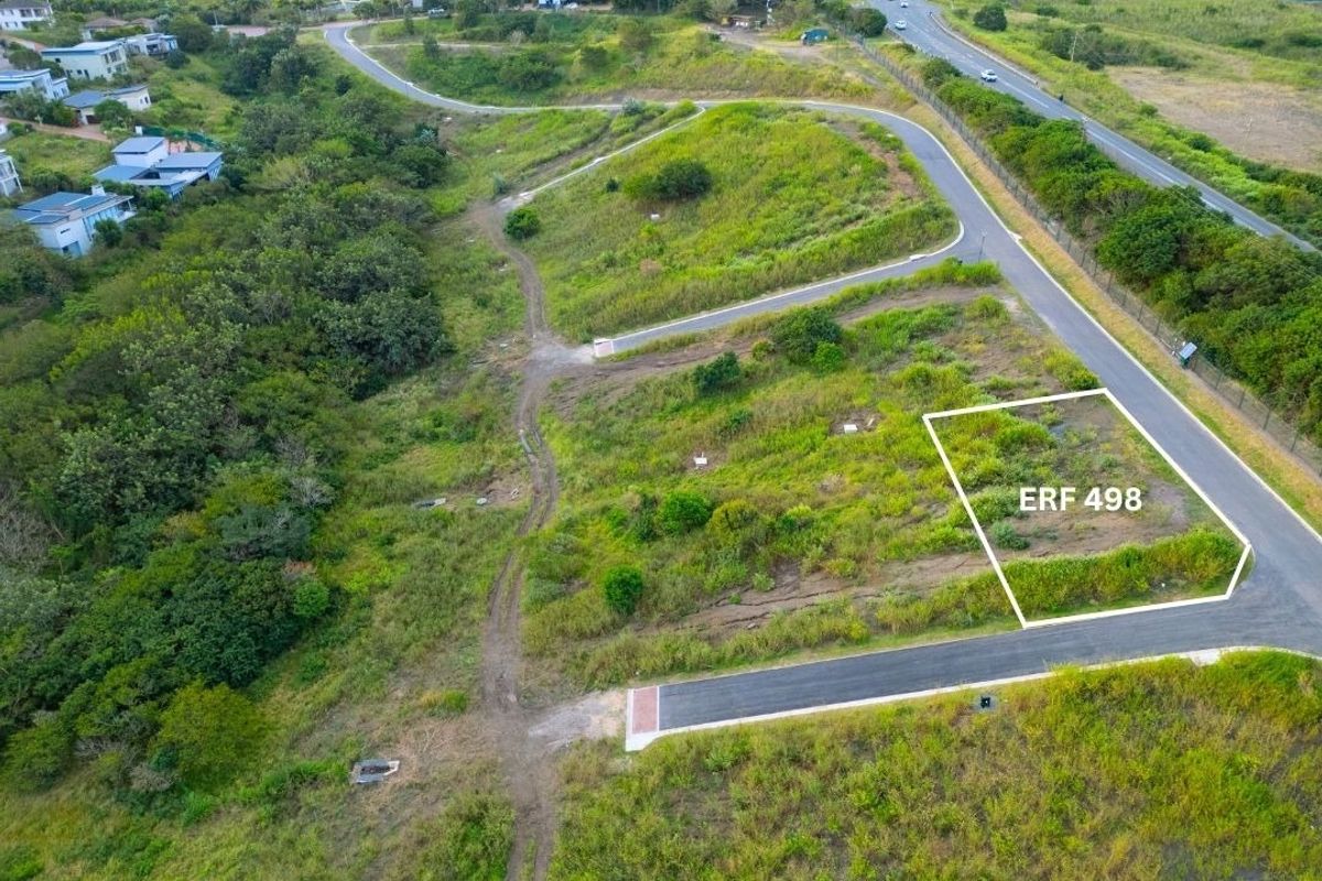 Aerial view of vacant residential plot ERF 498, featuring established road access and surrounding natural landscape in a residential estate setting.