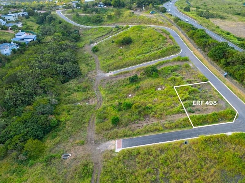 Aerial view of vacant residential plot ERF 498, featuring established road access and surrounding natural landscape in a residential estate setting.