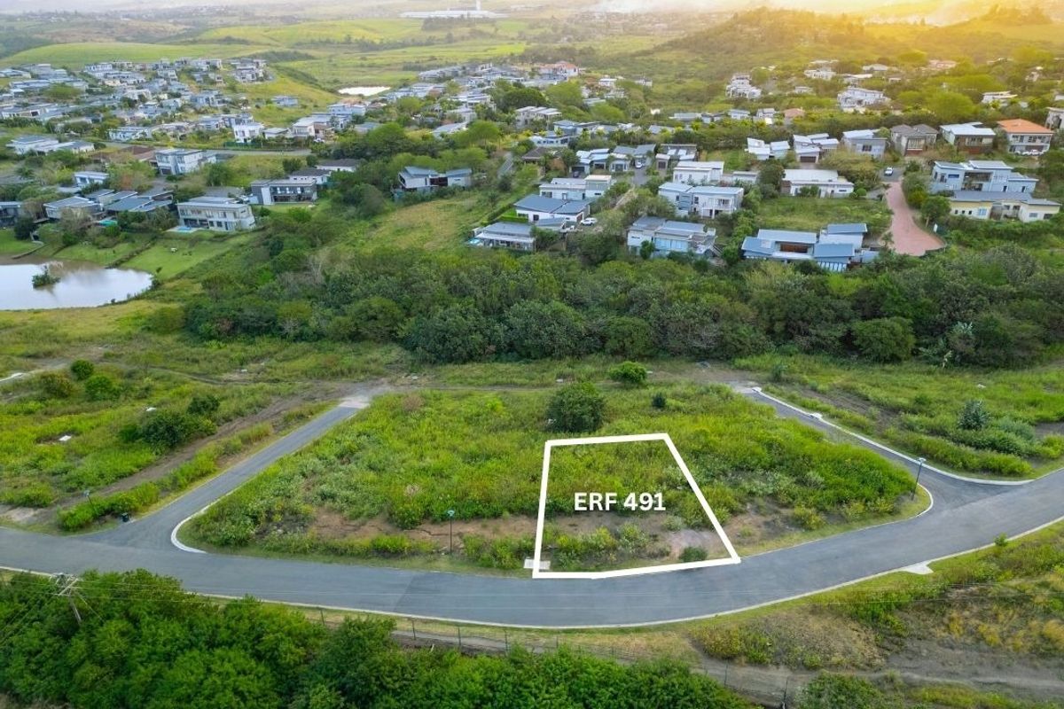 An aerial view of a vacant residential plot, identified as Erf 491, situated within a developed estate with established road access and surrounding greenery.