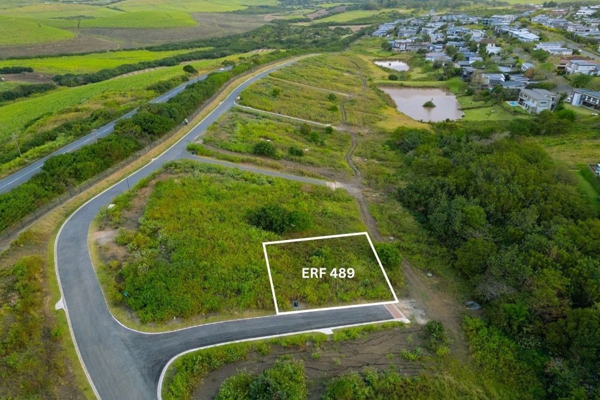 Aerial view of vacant residential plot ERF 489, featuring established road access and surrounding green landscape in a residential estate.