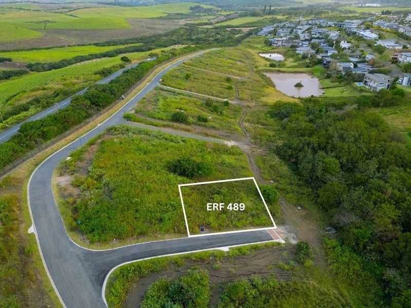 Aerial view of vacant residential plot ERF 489, featuring established road access and surrounding green landscape in a residential estate.