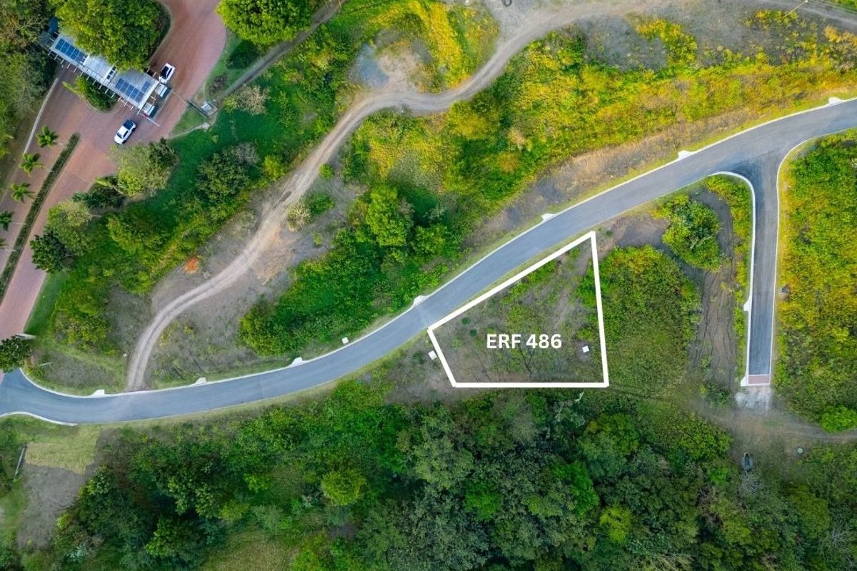 Aerial view of a vacant residential plot, Erf 486, featuring direct road access and surrounding natural vegetation.