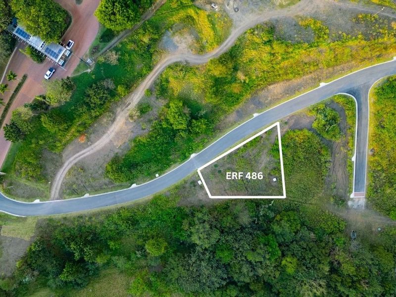 Aerial view of a vacant residential plot, Erf 486, featuring direct road access and surrounding natural vegetation.