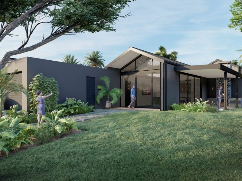 Modern architectural house exterior featuring a pitched roof, large glass windows, and a landscaped garden with a paved walkway.