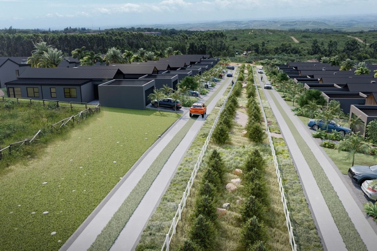 Aerial view of a modern residential estate featuring uniform dark-toned homes with pitched roofs, paved driveways, and landscaped green belts.