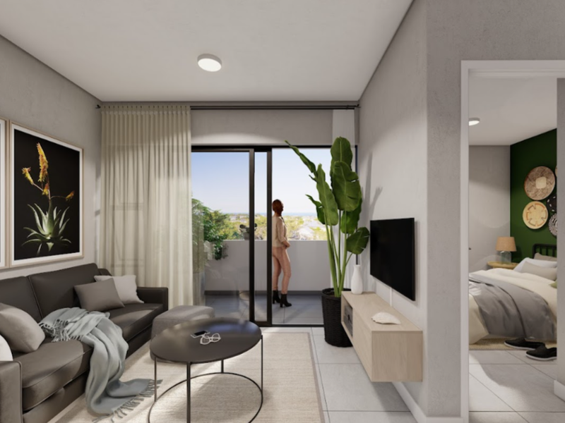 Modern open-plan living area featuring tiled floors, recessed lighting, and a sliding glass door leading to a private balcony with views.