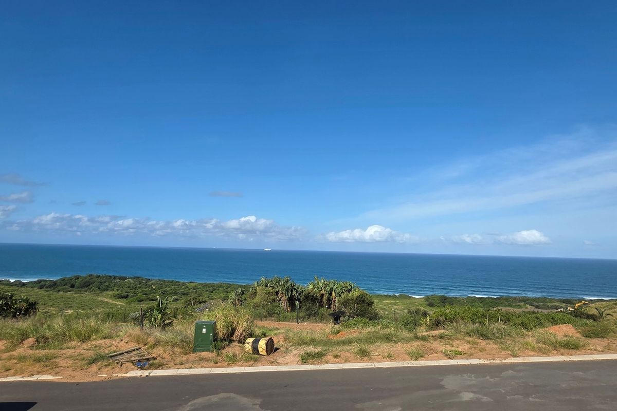 A scenic view of the coastline and ocean from the vacant residential land plot.
