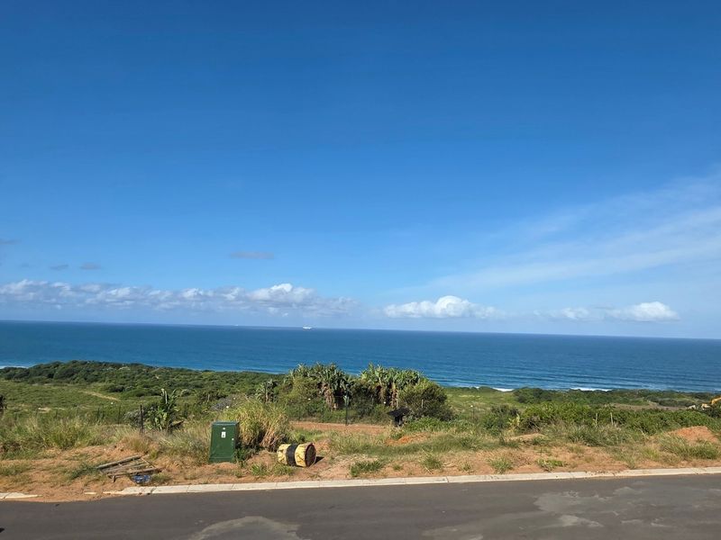 A scenic view of the coastline and ocean from the vacant residential land plot.