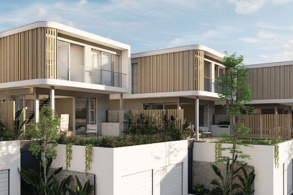 Modern townhouse development featuring timber batten cladding, glass balustrades, and stone masonry accents with integrated garage access and private patio spaces.