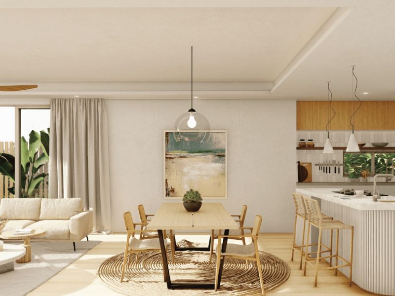 Modern open-plan living and dining area featuring a sleek kitchen island, contemporary pendant lighting, and seamless access to the outdoor space.