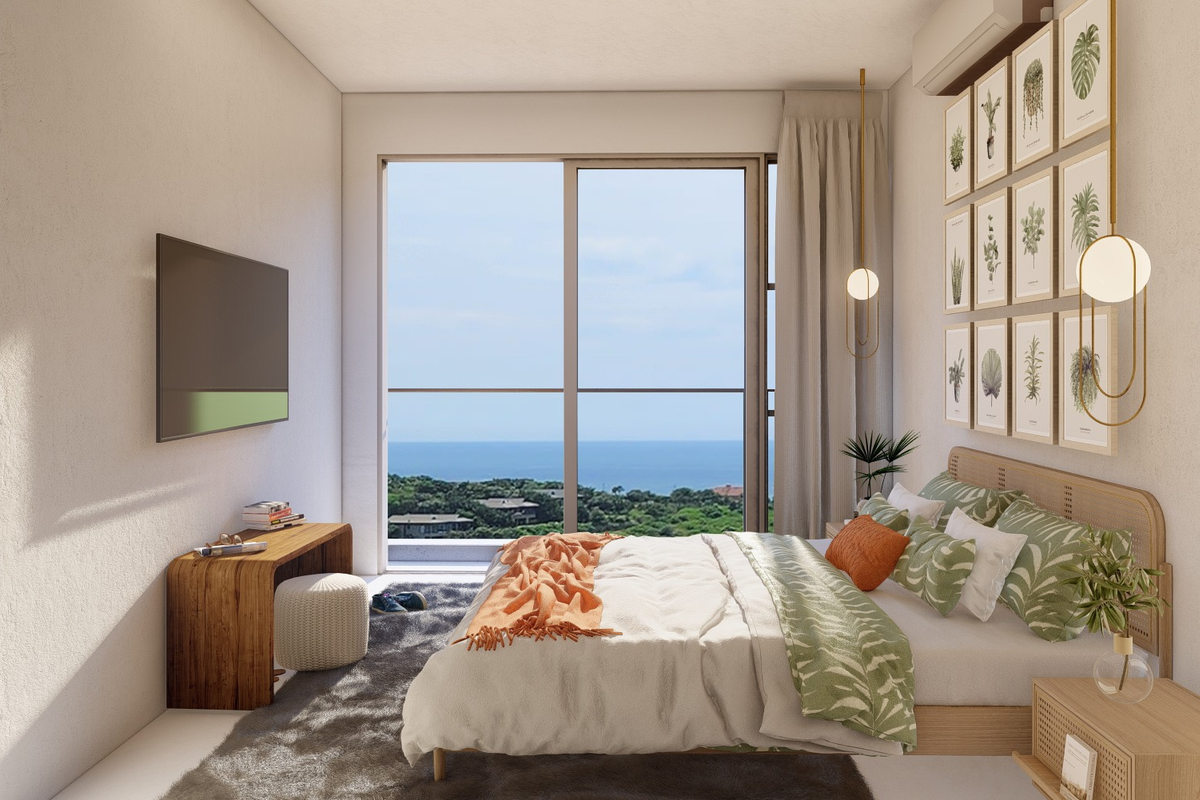 A modern bedroom featuring a large sliding glass door with scenic ocean views, integrated air conditioning, and contemporary pendant lighting.