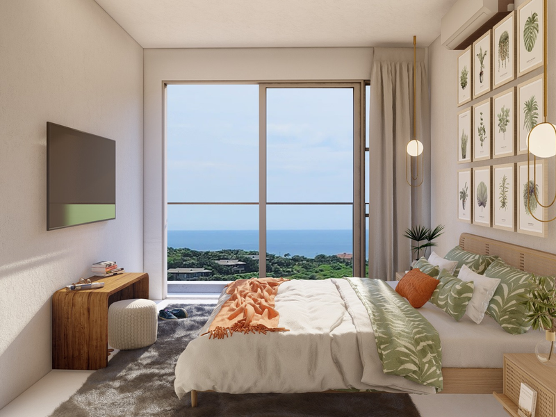 A modern bedroom featuring a large sliding glass door with scenic ocean views, integrated air conditioning, and contemporary pendant lighting.