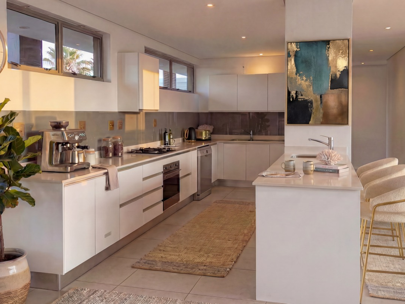 Modern kitchen featuring sleek white cabinetry, stone countertops, a central island with seating, and high-quality built-in appliances in a bright, open-plan layout.