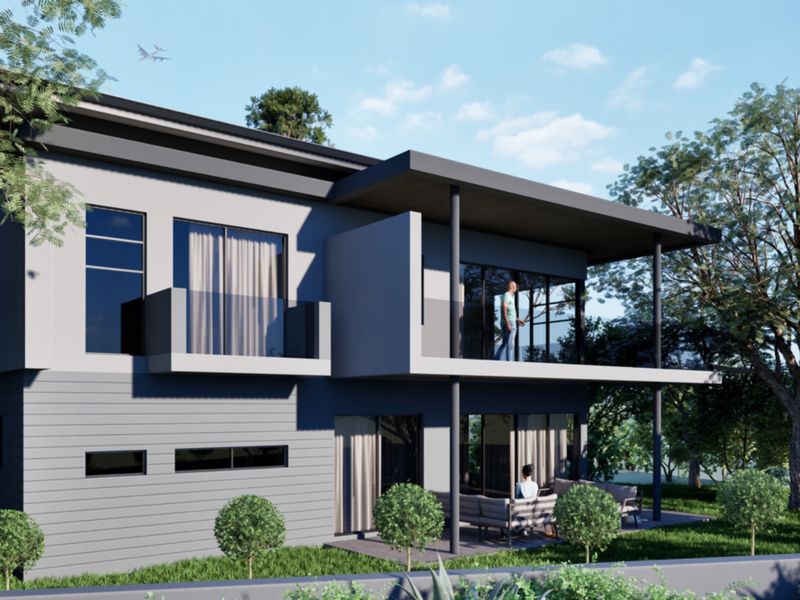 A modern two-story townhouse exterior featuring a rear patio, upper-level balcony with glass balustrades, and contemporary architectural design.