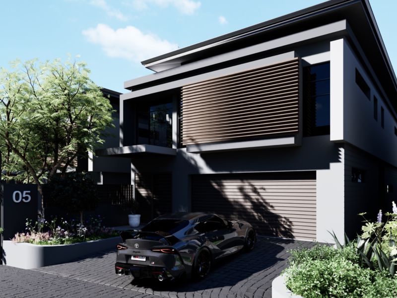 Modern townhouse exterior featuring a sleek facade with timber slat detailing, a double garage, and a paved driveway with landscaped garden beds.