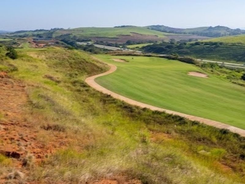 A scenic elevated view overlooking a well-maintained golf course fairway and surrounding rolling landscape.