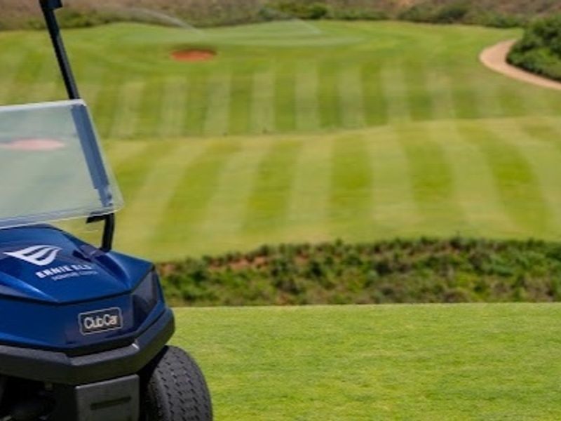 A scenic view overlooking a well-maintained golf course fairway and sand bunker.
