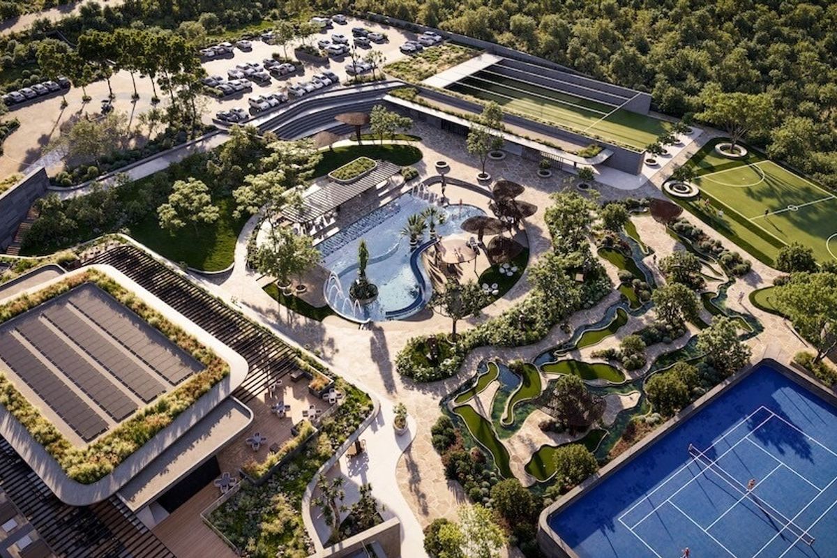 An aerial view of a luxury residential estate featuring a swimming pool, tennis court, soccer field, mini golf course, and extensive landscaped grounds.
