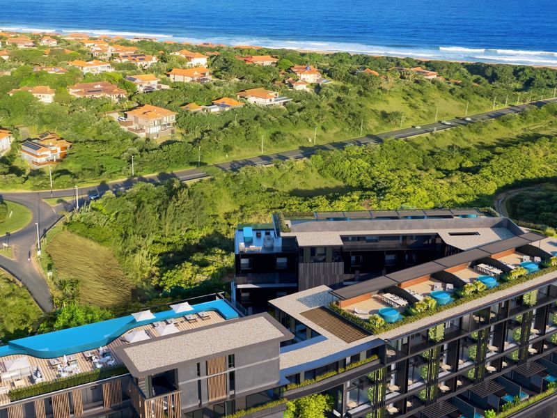 Aerial view of a modern penthouse complex featuring rooftop swimming pools, landscaped terraces, and proximity to the coastline.