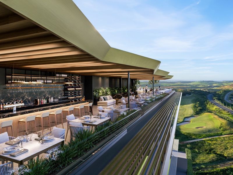 A luxury open-air penthouse bar and terrace featuring a built-in bar counter, integrated wine storage, and panoramic views of the surrounding landscape.