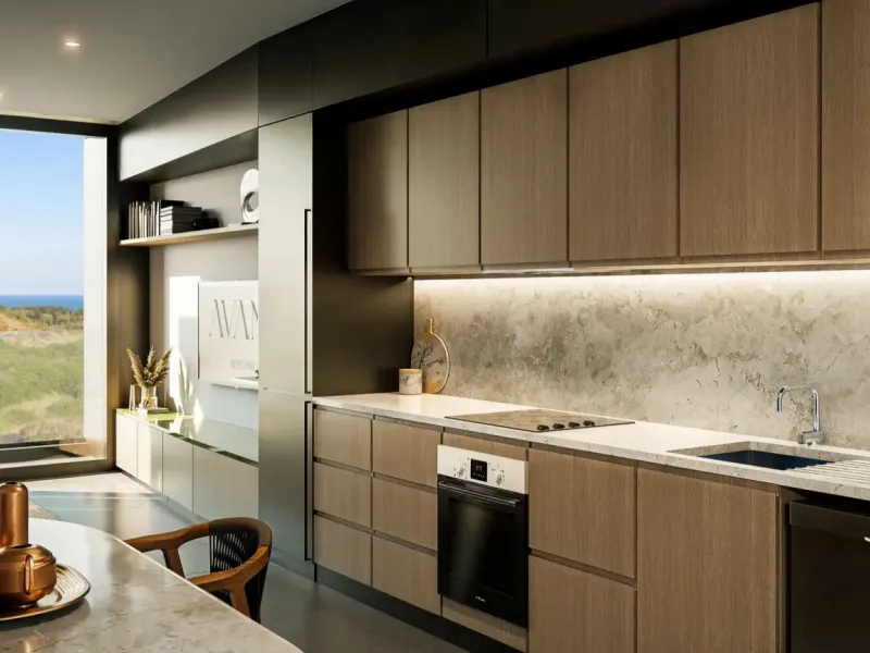Modern open-plan kitchen featuring sleek wood-tone cabinetry, stone countertops, integrated appliances, and expansive windows offering scenic coastal views.