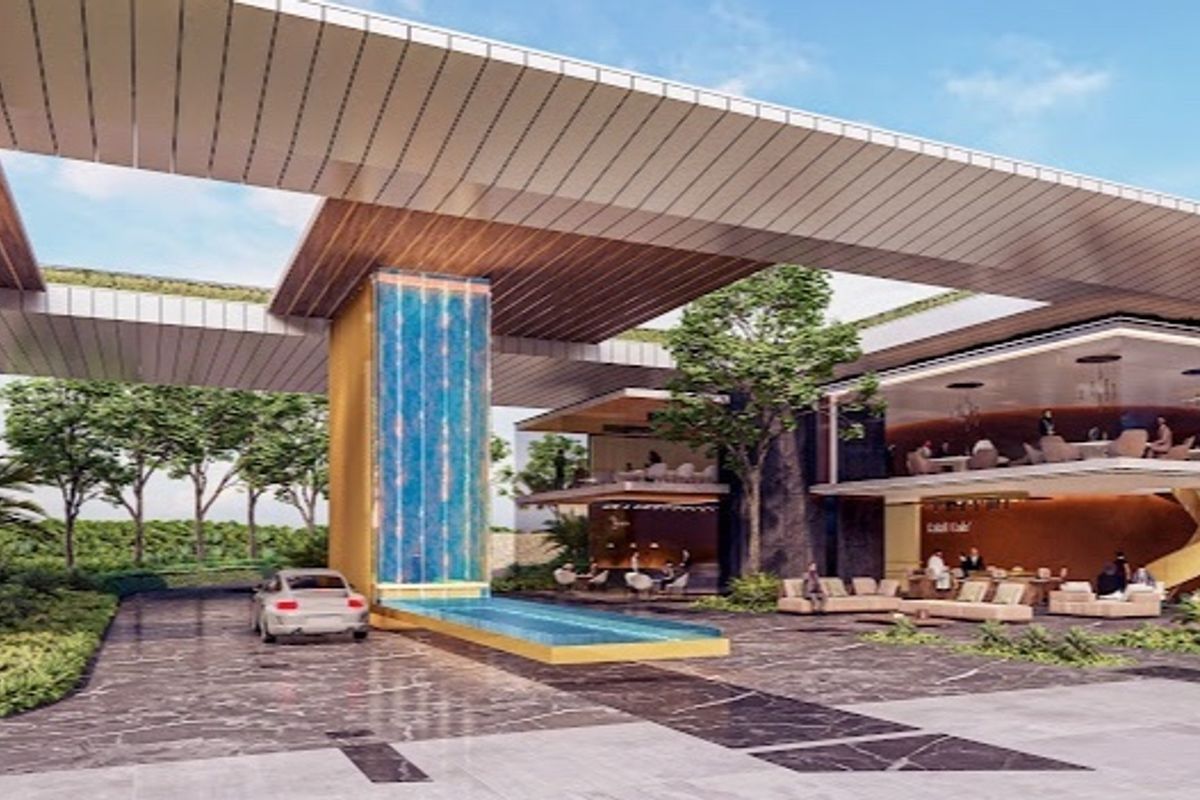 A modern architectural entrance featuring a prominent water feature, expansive paved driveway, and a contemporary multi-level structure with integrated canopy design.