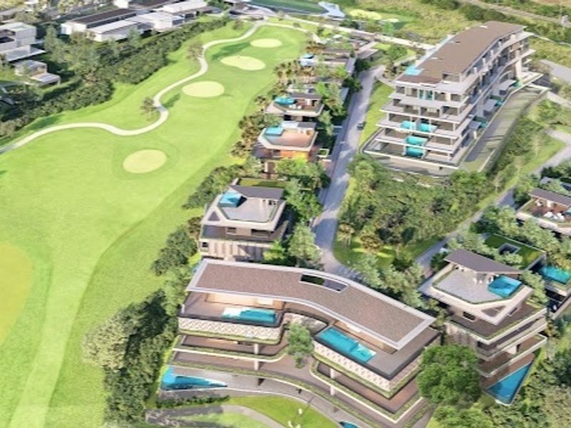 An aerial perspective of a luxury residential development integrated with a golf course, featuring modern multi-story buildings and private swimming pools.