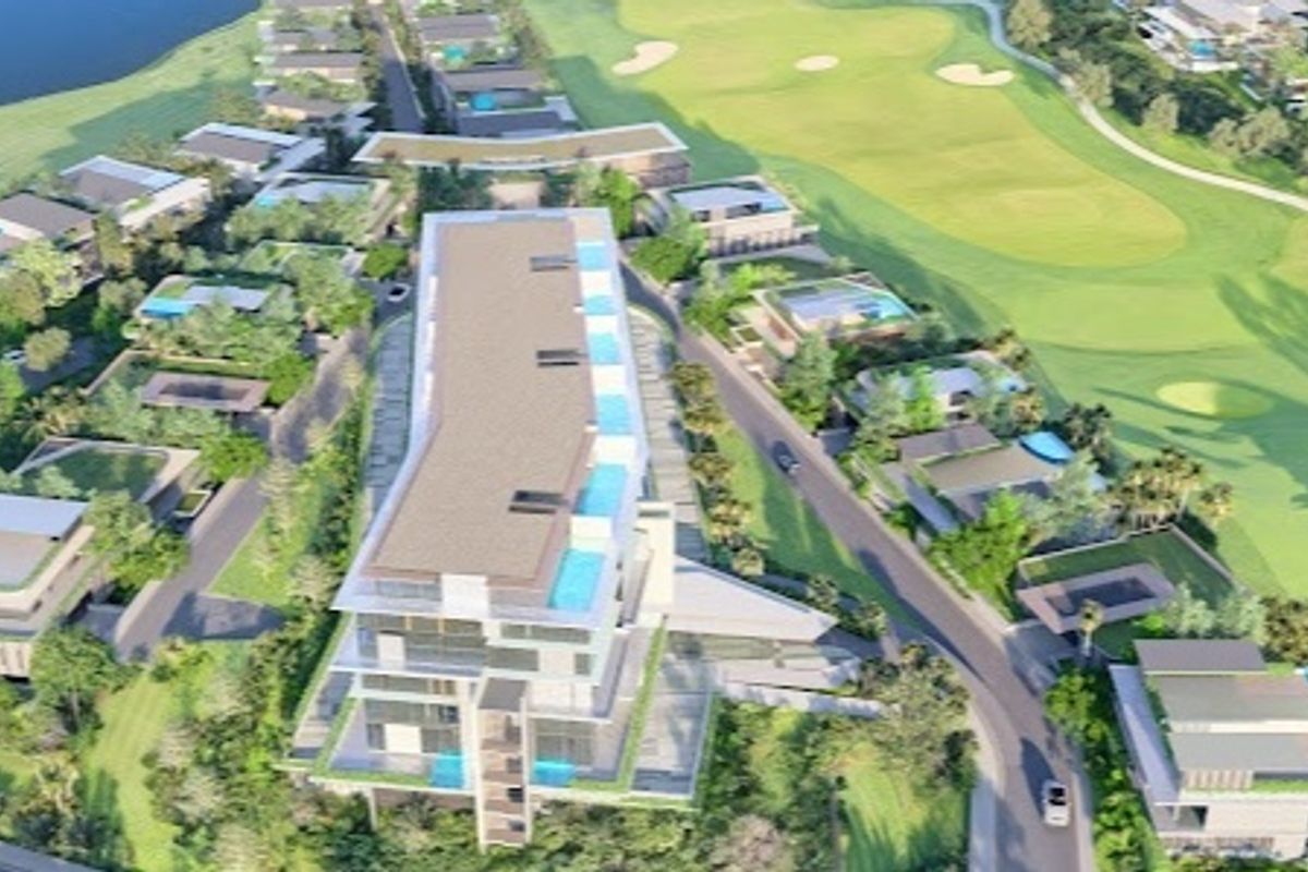An aerial view of a residential development situated adjacent to a golf course, featuring multiple buildings and swimming pools.