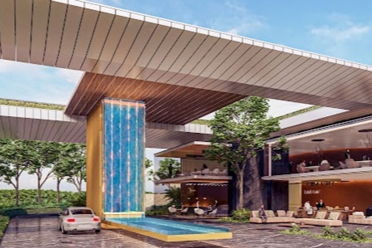 A modern architectural clubhouse entrance featuring a striking water feature, expansive covered driveway, and contemporary design elements.