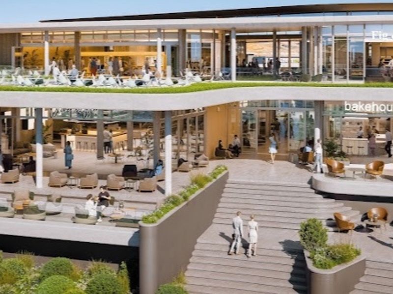 Modern multi-level commercial building exterior featuring a grand staircase, expansive glass facades, and integrated outdoor terrace seating areas.