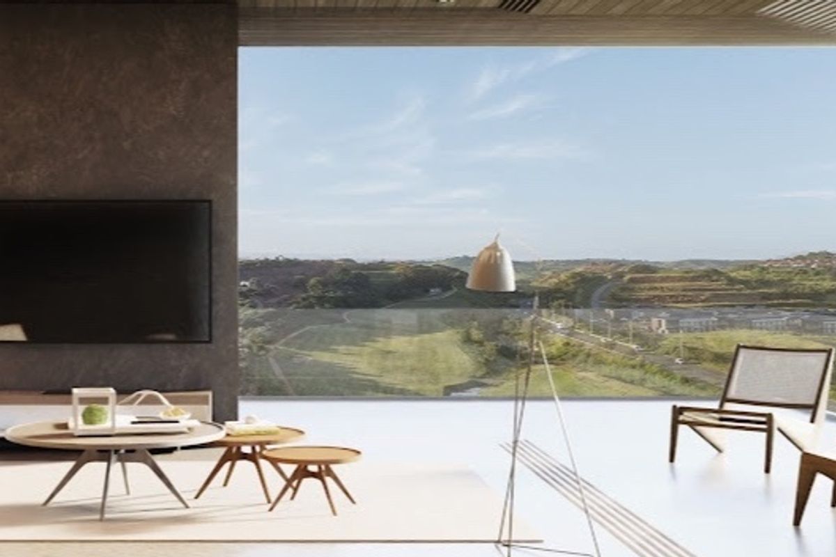 Modern open-plan living area featuring a dark feature wall and expansive floor-to-ceiling glass doors opening to a scenic landscape view.