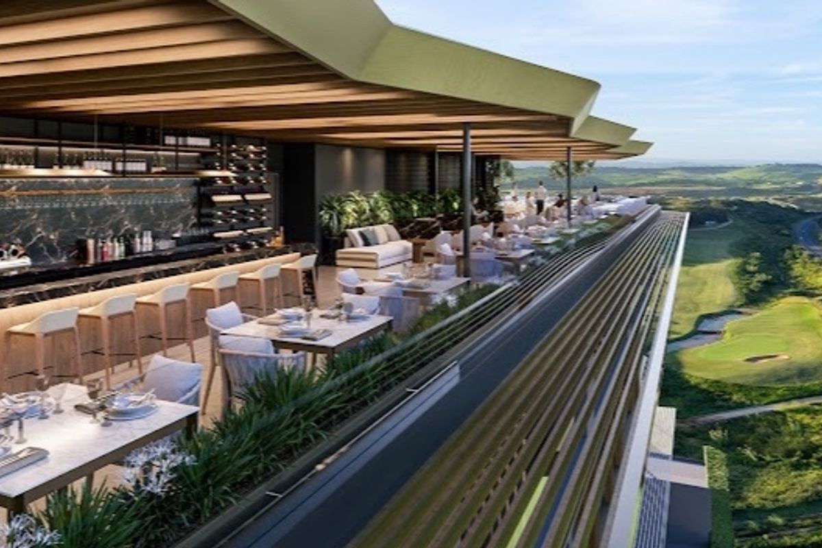 A sophisticated outdoor bar area featuring a built-in counter and integrated wine storage, set under a modern architectural roof with expansive golf course views.