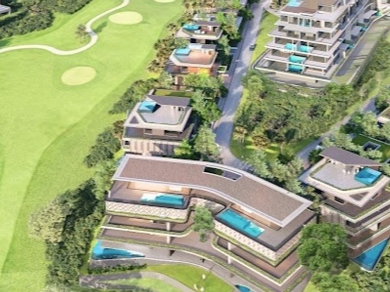 An aerial view of a luxury residential development featuring multi-level buildings with private pools, situated adjacent to a golf course.