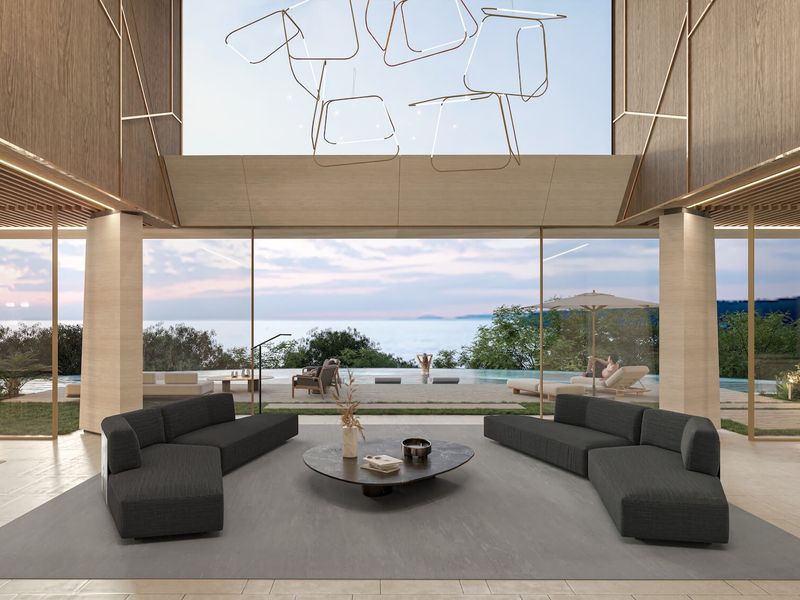 A luxurious, modern open-plan living area featuring floor-to-ceiling glass walls with expansive ocean views and high-end architectural finishes.