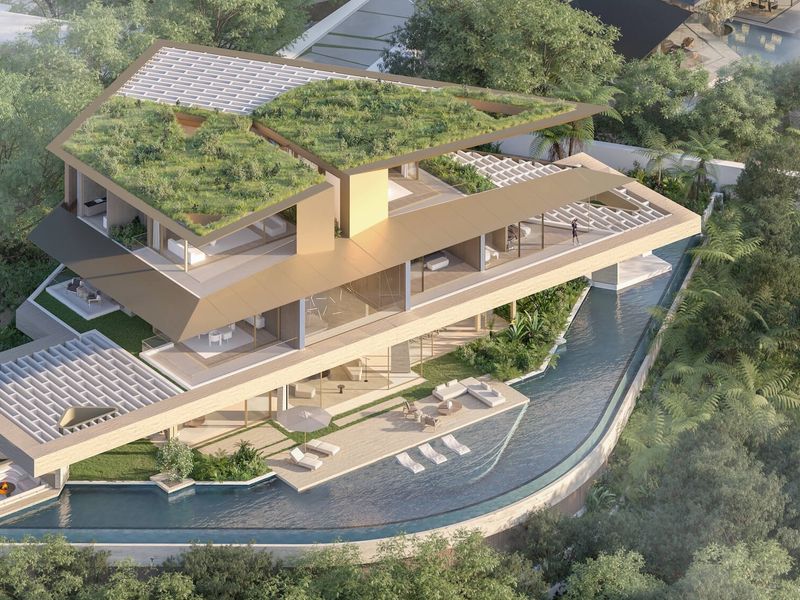 An aerial perspective of a modern luxury residence featuring a green roof, expansive terraces, and a sleek swimming pool integrated into a lush landscape.